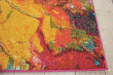 Close up of Nourison Celestial Cayenne rug showing abstract design, cayenne, yellow, and blue hues.