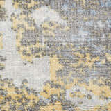 Close-up of Nourison Safari Dreams Ivory Gold rug. Painterly design in gold, ivory, gray, and blue hues. Handmade texture.