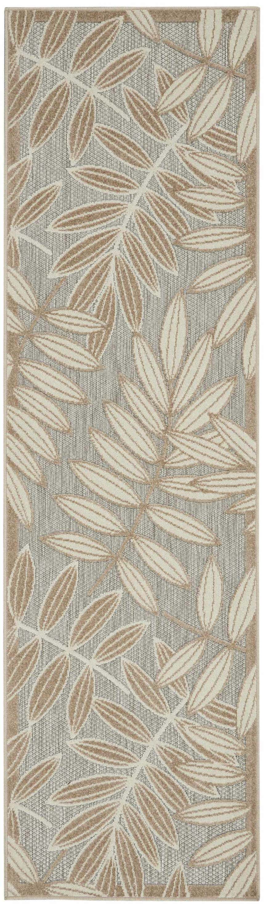 Close-up of Nourison Aloha Natural Tropical Area Rug. Beige leaves on a gray textured background. Tropical style.