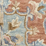 Close-up of the Nourison Maison Rust Ivory rug showing vintage design, chestnut, ivory, and blue colors, and handmade texture.
