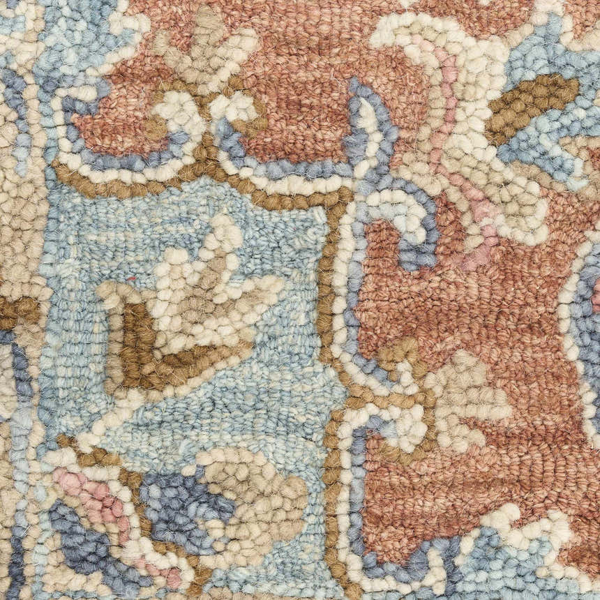 Close-up of the Nourison Maison Rust Ivory rug showing vintage design, chestnut, ivory, and blue colors, and handmade texture.