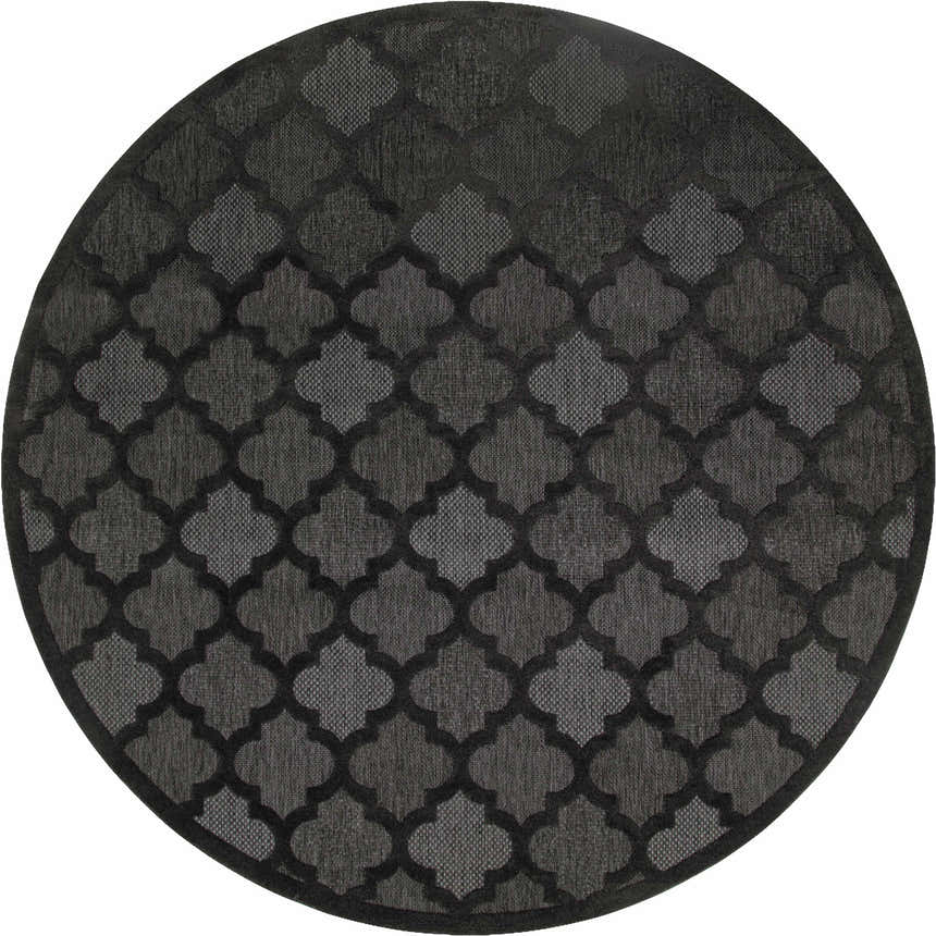 Close-up of a round Nourison Easy Care Charcoal Black rug featuring a quatrefoil pattern in shades of gray and black.