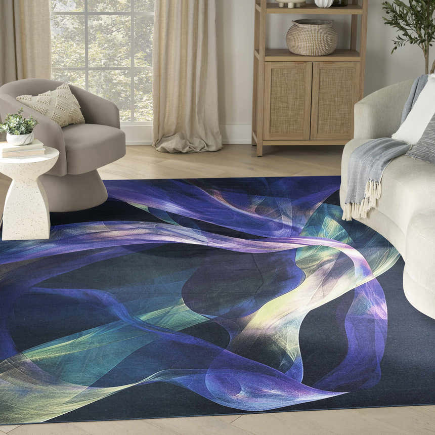 Living room scene with the Nourison Blue Multicolor Modern Washable Area Rug, light wood floors, and neutral furniture.