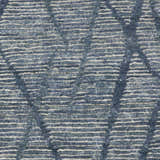 Close-up of the Nourison OCEAN Indigo rug. Handmade with a textured, horizontal striped pattern in indigo and cream.