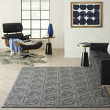 Modern living room with a Nourison Cozumel Dark Grey rug, black chair, and gray sofa.