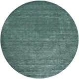 Close-up of a round Feizy Luna Modern Solid Area Rug in green and white, hand woven with a subtle texture. Design-Round