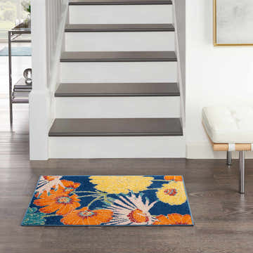 Entryway with Nourison Allur Navy Multicolor rug. Floral runner by stairs on dark wood floor. Contemporary style.