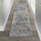 Hallway with grey wood floors and Michael Amini MA90 Uptown Grey runner rug. Modern, neutral tones.