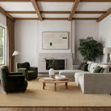 Living room scene with a Nourison Plush Cloud Camel rug, gray sofa, green chairs, and wood accents.
