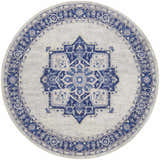 Round Nourison Whimsicle Ivory Blue rug. Farmhouse style rug with a blue medallion pattern on an ivory background.