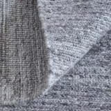 Close-up of the hand-knotted Feizy Finley Gray/Ivory rug showing its chunky, textured weave and neutral color palette. Fold