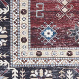Close-up of Nourison Fulton Red Vintage Area Rug. Features a detailed geometric and floral pattern in red, black, and beige.