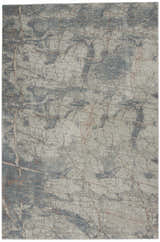 Close-up of Nourison Rustic Textures Light Grey Blue rug, showing a modern abstract pattern and subtle texture.