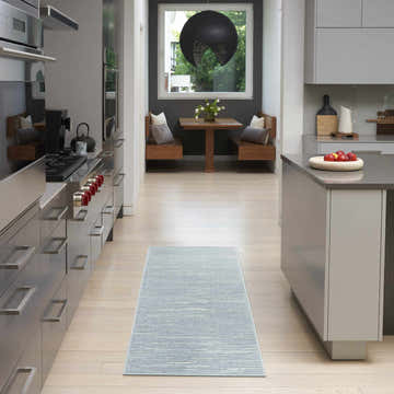 Modern kitchen with light wood floors and Nourison Care Free Blue runner rug.