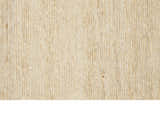 Close-up of the textured, neutral-toned Calvin Klein Mesa Gypsum rug. Handmade rayon and cotton fibers.