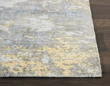 Close-up of Nourison Safari Dreams Ivory Gold rug showing painterly design, texture, and chestnut wood floor.