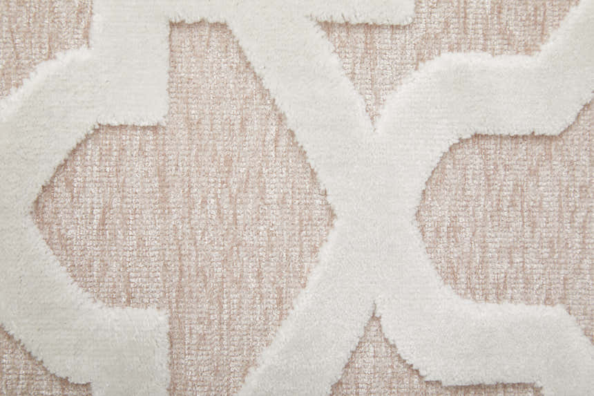 Close up of Feizy Saphir Mira rug. Pink and white interlocking geometric diamond pattern. Soft texture. Texture