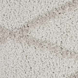Close-up of the plush, textured pile of the grey Nourison Feather Soft area rug. Casual style.