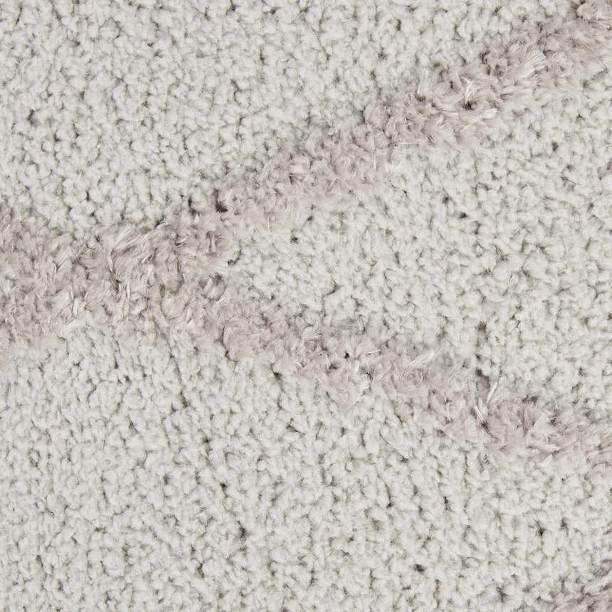 Close-up of the plush, textured pile of the grey Nourison Feather Soft area rug. Casual style.