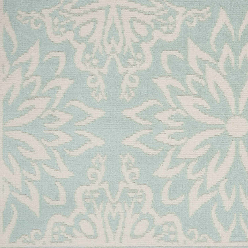 Close-up of the Nourison Jubilant Ivory Green rug, showcasing its floral pattern and soft texture.