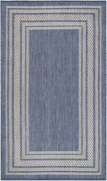 Close-up of the Nourison Horizon Denim Area Rug. Features a blue woven texture and a gray geometric border.