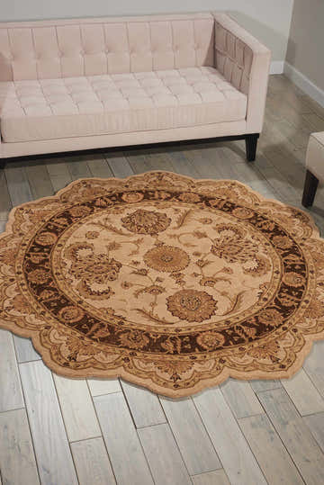 Living room scene with a beige sofa and round Nourison Heritage Hall Persian rug in beige.