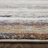 Close-up of Feizy Gilmore Modern Stripes rug showing ivory, orange, and gray colors and textured, machine-made construction. Pile