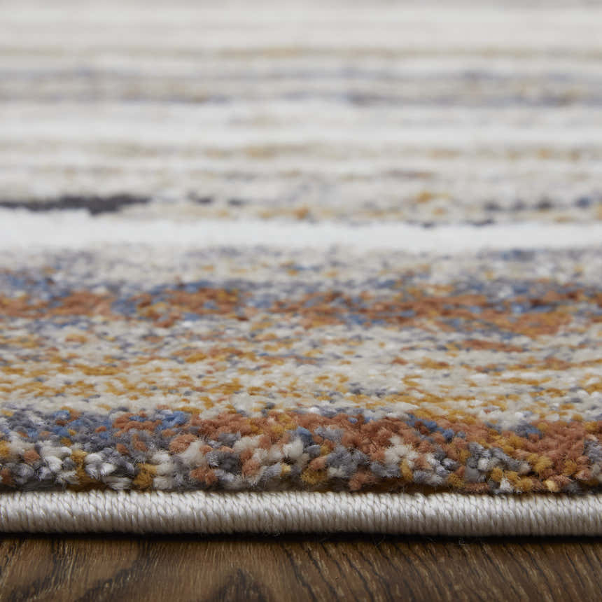 Close-up of Feizy Gilmore Modern Stripes rug showing ivory, orange, and gray colors and textured, machine-made construction. Pile