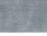 Close-up of the Calvin Klein Chicago Shag rug. The grey shag texture is soft and plush. Modern style.