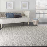 Living room with a tufted sofa and Nourison Grafix Grey Contemporary Area Rug with a swirling pattern.