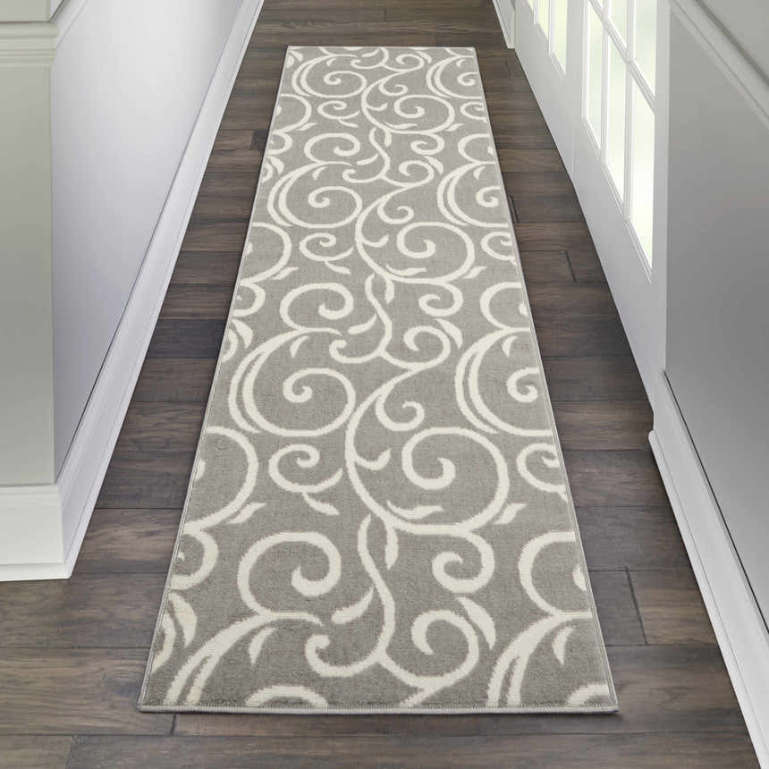 Hallway scene with a Nourison Grafix Grey rug runner on dark wood floors, showcasing a white swirling pattern.
