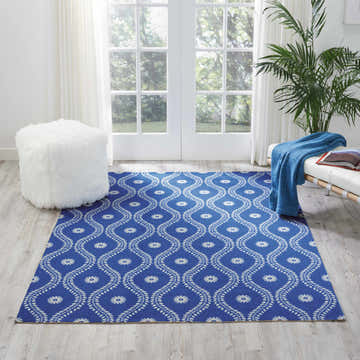 Coastal living room with Nourison Home & Garden Navy rug, white furniture, and natural light. Nautical, beachy style.