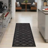 Modern kitchen scene with a Nourison Easy Care Charcoal Black runner rug on light wood floors.
