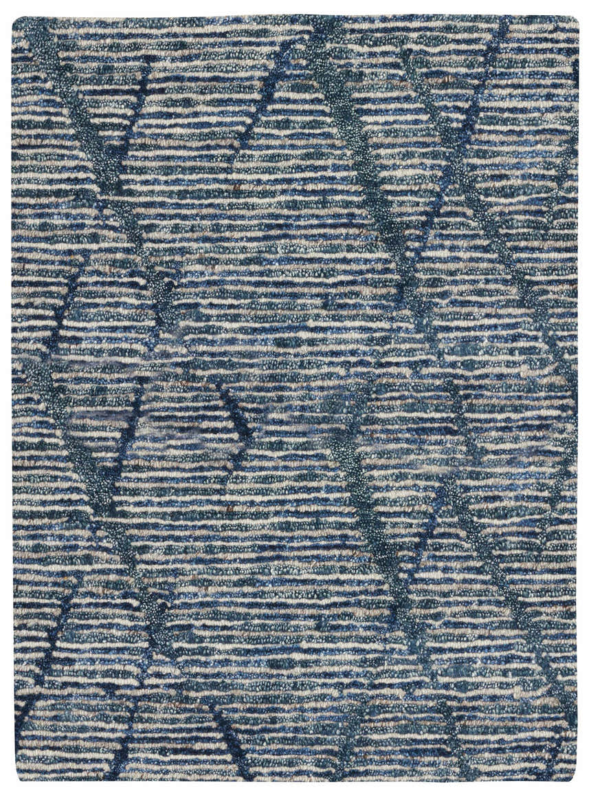Close-up of the Nourison OCEAN Indigo rug. Handmade, mid-century modern style with horizontal stripes and purple accents.