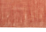 Close-up of the Calvin Klein Home Lunar Rust rug, showing its soft texture and subtle vertical stripe pattern.