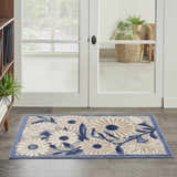 Entryway with Nourison Aloha Blue Grey Outdoor Area Rug, featuring a floral pattern and blue border.