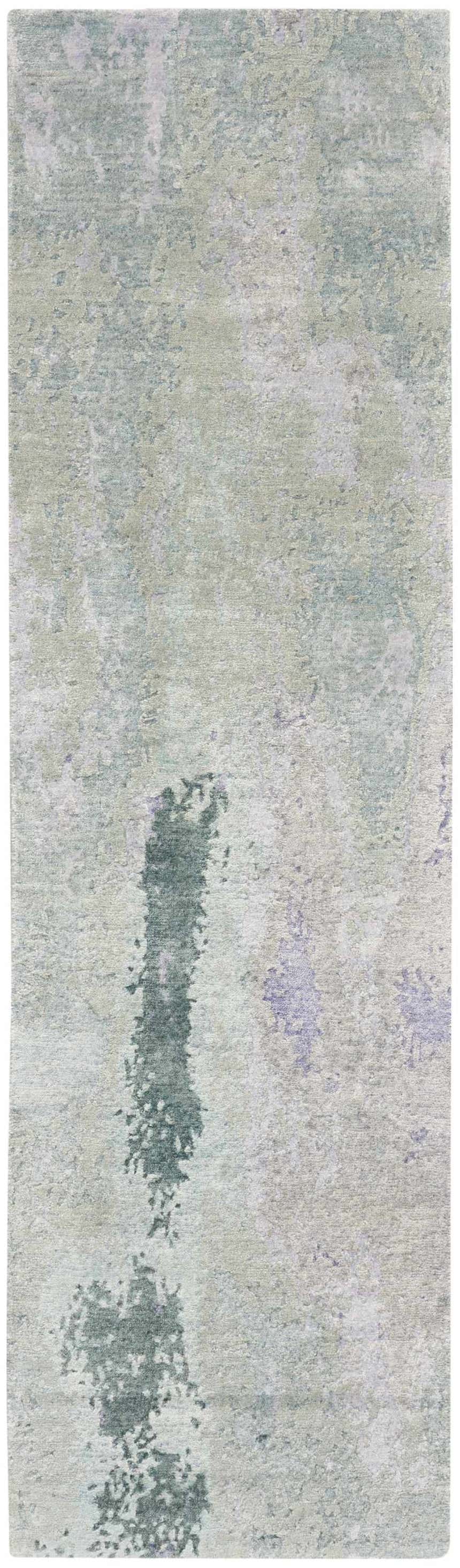 Close-up of the Nourison Silk Shadows Blue Green rug. Abstract pattern in shades of blue, green, and gray. Soft, silk-like texture.