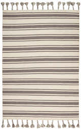 Close-up of Nourison Rio Vista Ivory/Grey rug. Bohemian style, handmade wool rug with chestnut brown stripes and tassels.