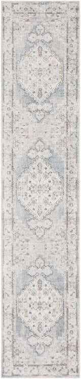 Close-up of Nourison Astra Light Blue Vintage rug. Machine-made with distressed diamond and geometric patterns.