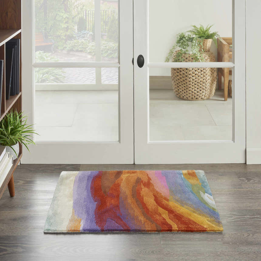 Entryway with Nourison Prismatic Multicolor rug. Modern design in purple, orange, and yellow on wood floor. Bright, inviting space.
