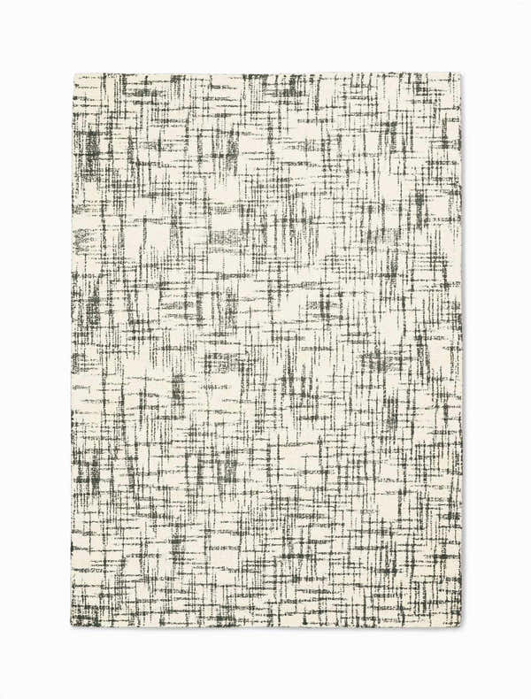 Close-up of Calvin Klein Tucson Ivory/Grey rug. Handmade wool rug with a modern, abstract grid pattern.