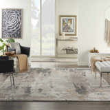 Living room scene with cream walls and Nourison Tangra Cream Grey rug, black chairs, and white bench.