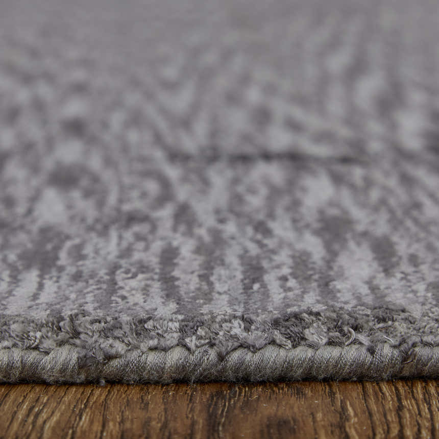 Close-up of the Feizy Marlowe rug in gray and taupe. Hand-woven viscose rug with a subtle chevron pattern. Pile