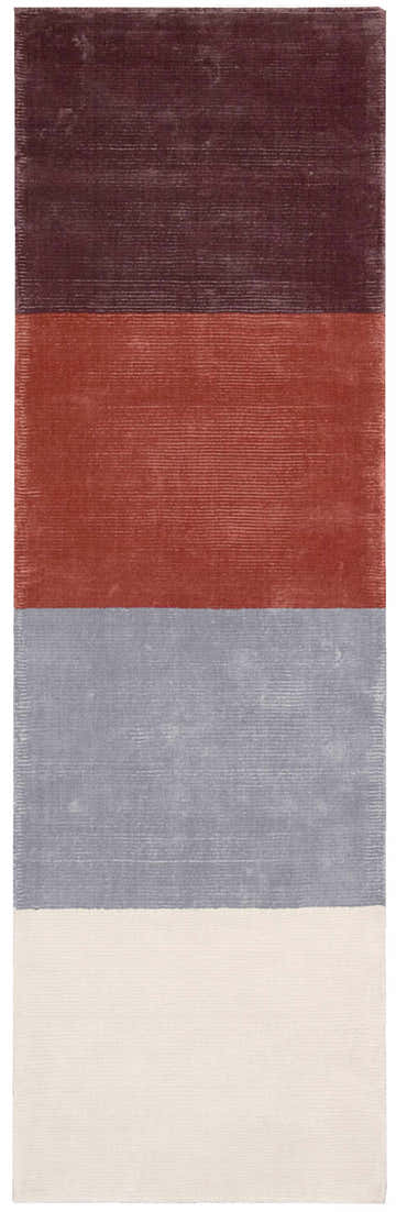Close-up of the Calvin Klein Home Lunar rug. Features purple, rust, platinum, and shell color blocks. Handmade texture.