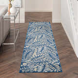 Hallway with Nourison Aloha Ivory Navy Tropical runner rug, wood floors, console table, and neutral decor.