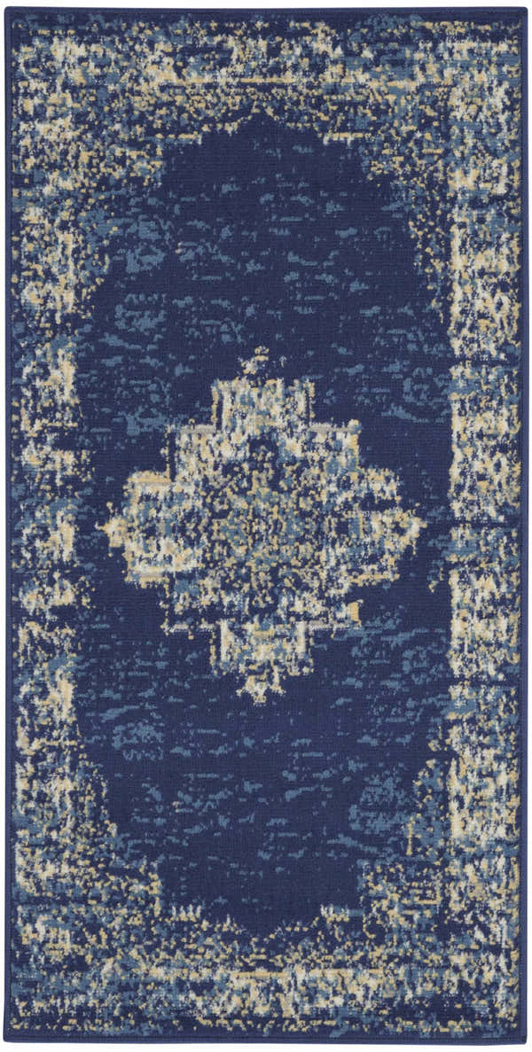 Close-up of the Nourison Grafix Navy Blue Vintage Area Rug. Features a distressed, ornate pattern in navy, blue, and beige tones.