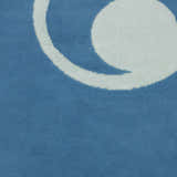 Close-up of the blue Nourison Grafix area rug with a white circular design.