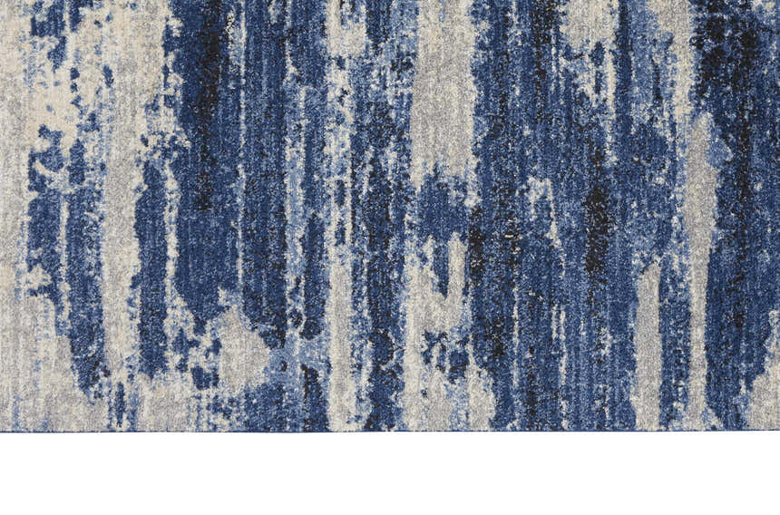 Close-up of Calvin Klein River Flow Rug. Blue, gray, and black abstract pattern. Modern design.