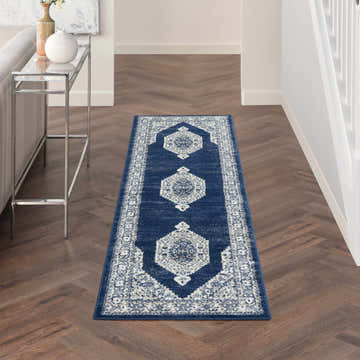 Hallway scene with Nourison Cyrus Ivory Navy runner rug on wood floor.