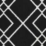 Close-up of the Nourison Modern Lines Black rug, featuring a geometric diamond pattern in white on a textured black background.